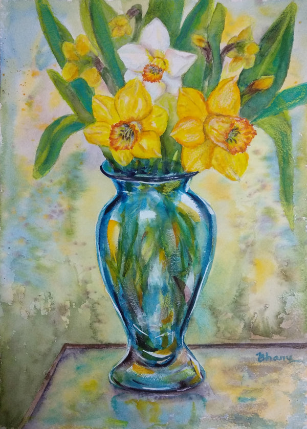 Blue glass vase of Daffodils on glass table in the Garden - flowers