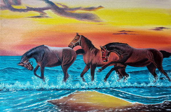 Three Horses running on a beach